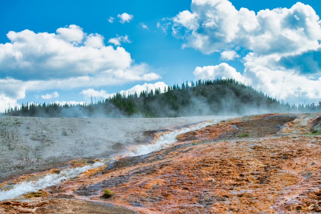 Geyser in Yellowstone showing the power of geothermal energy.